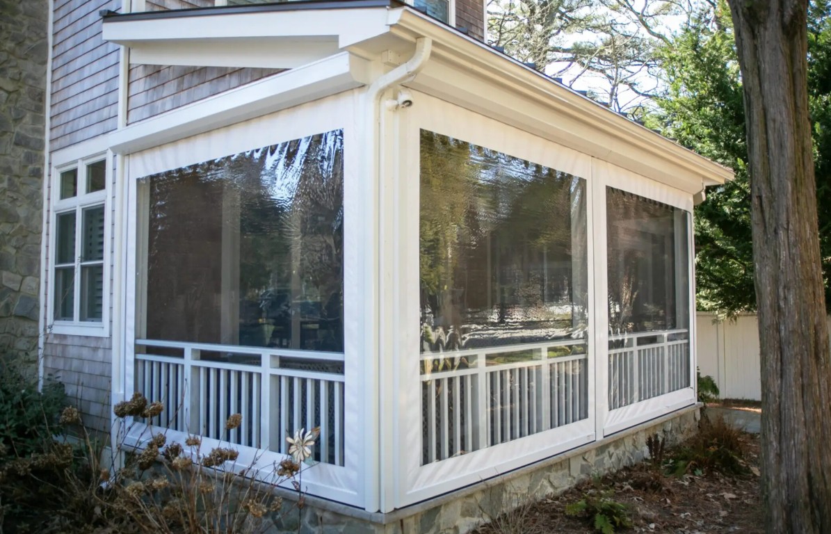 Three-season sunroom with screened windows and white railings in Harlingen, TX