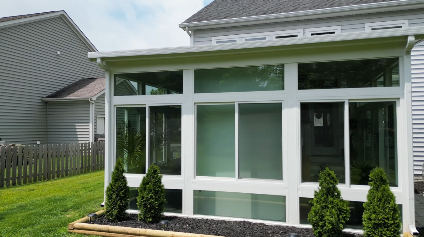 Premium patio enclosure with glass panels and decorative plants in Harlingen, TX